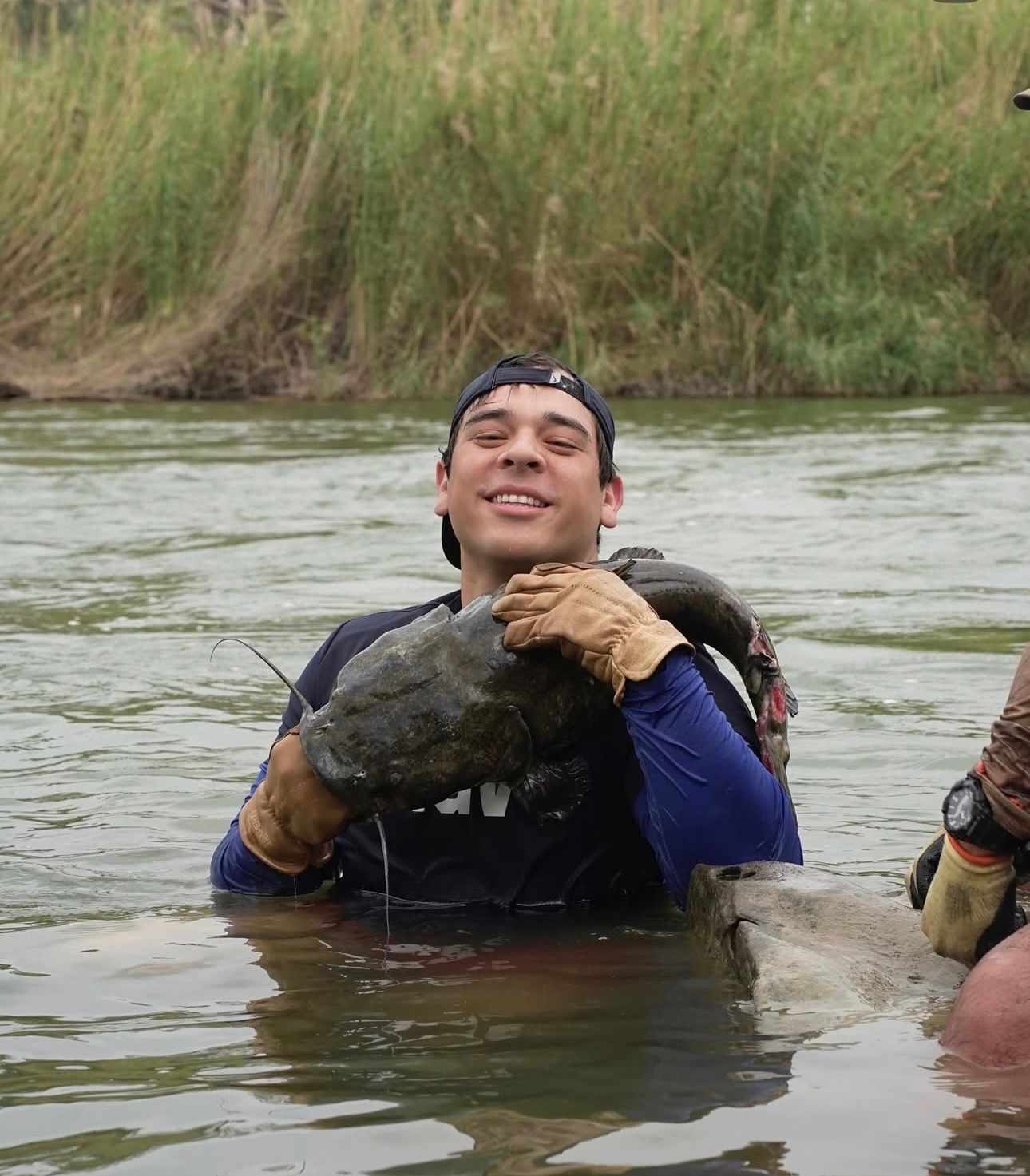 Hand-grabbing a big catfish on a South Texas noodling trip