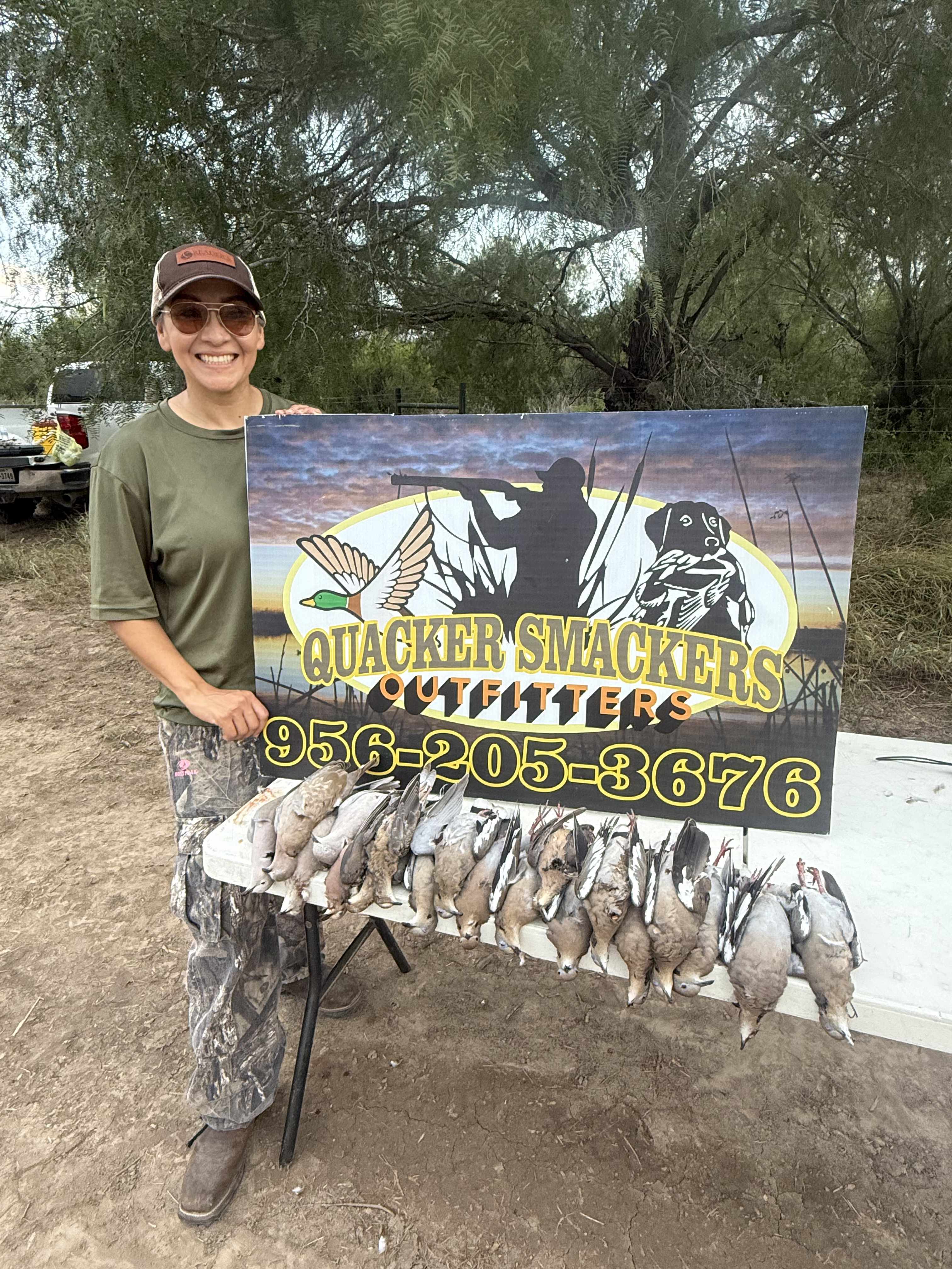 Quacker Smackers Outfitters sign with a duck strap