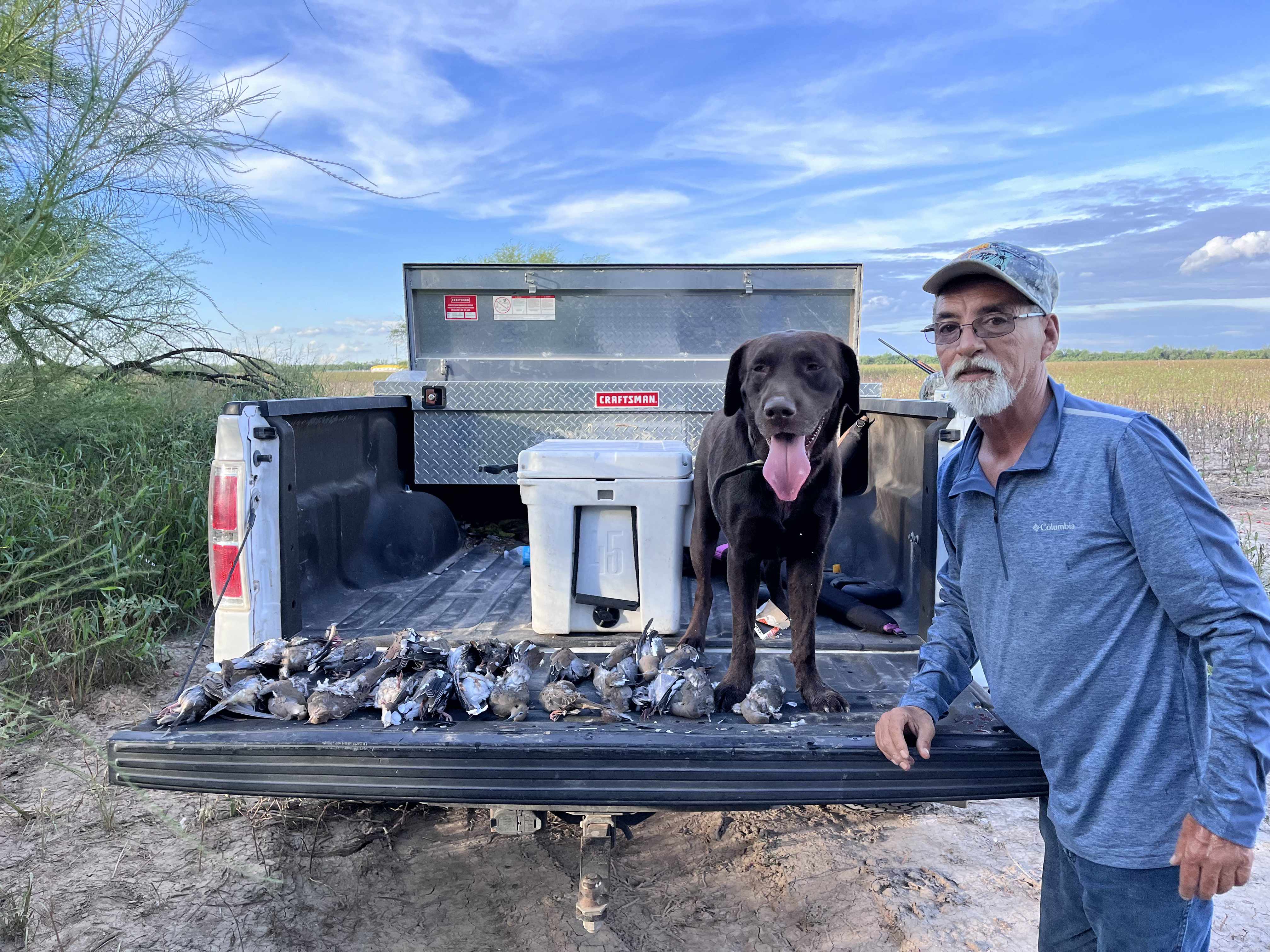 Tailgate full of ducks with the retriever